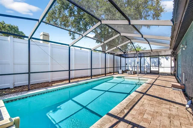 an aerial view of a house with a yard and potted plants