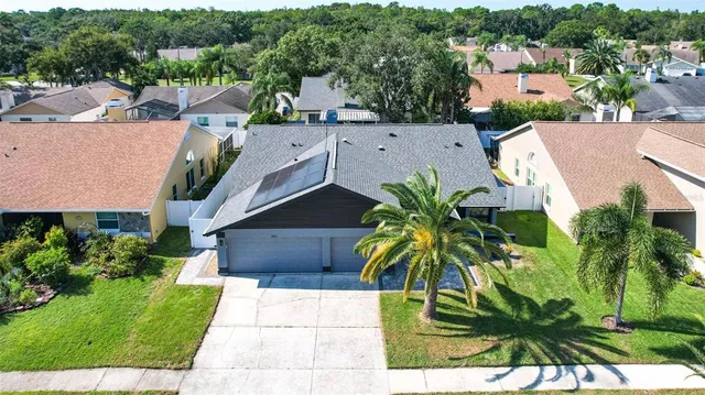 an aerial view of a houses with a lake and a mountain
