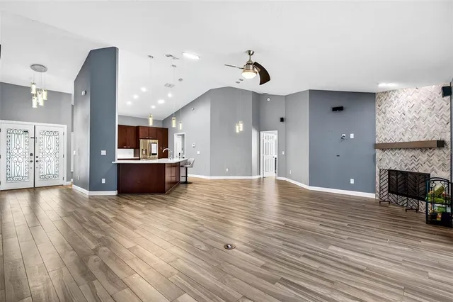 a view of kitchen and hall with wooden floor