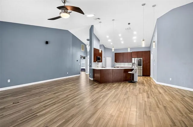 a view of a kitchen with a sink and wooden floor