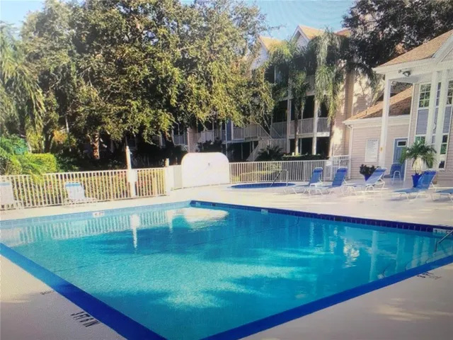 a view of a swimming pool with a outdoor seating