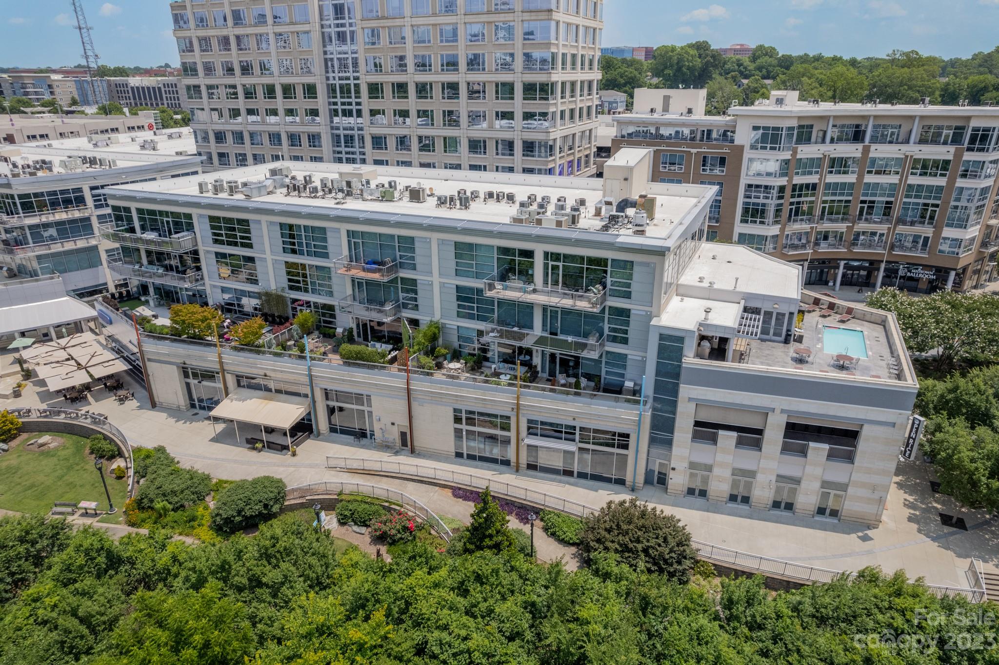 1100 Metropolitan Avenue, Unit 208 Charlotte, NC 28204 - Photo 1 of 30 an aerial view of a building with a garden and plants