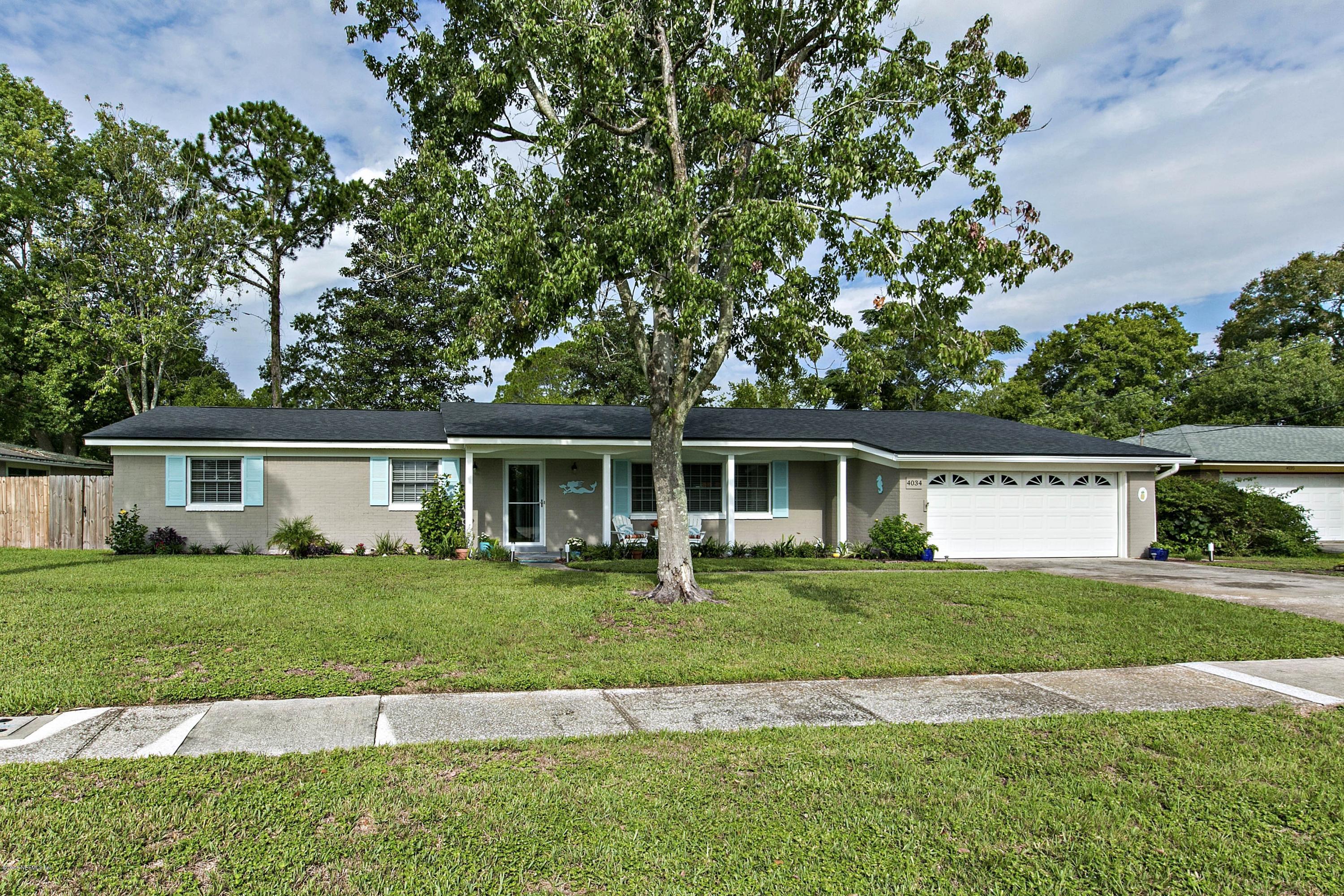 4034 Eunice Road Jacksonville, FL 32250 - Photo 1 of 24 a front view of a house with a garden