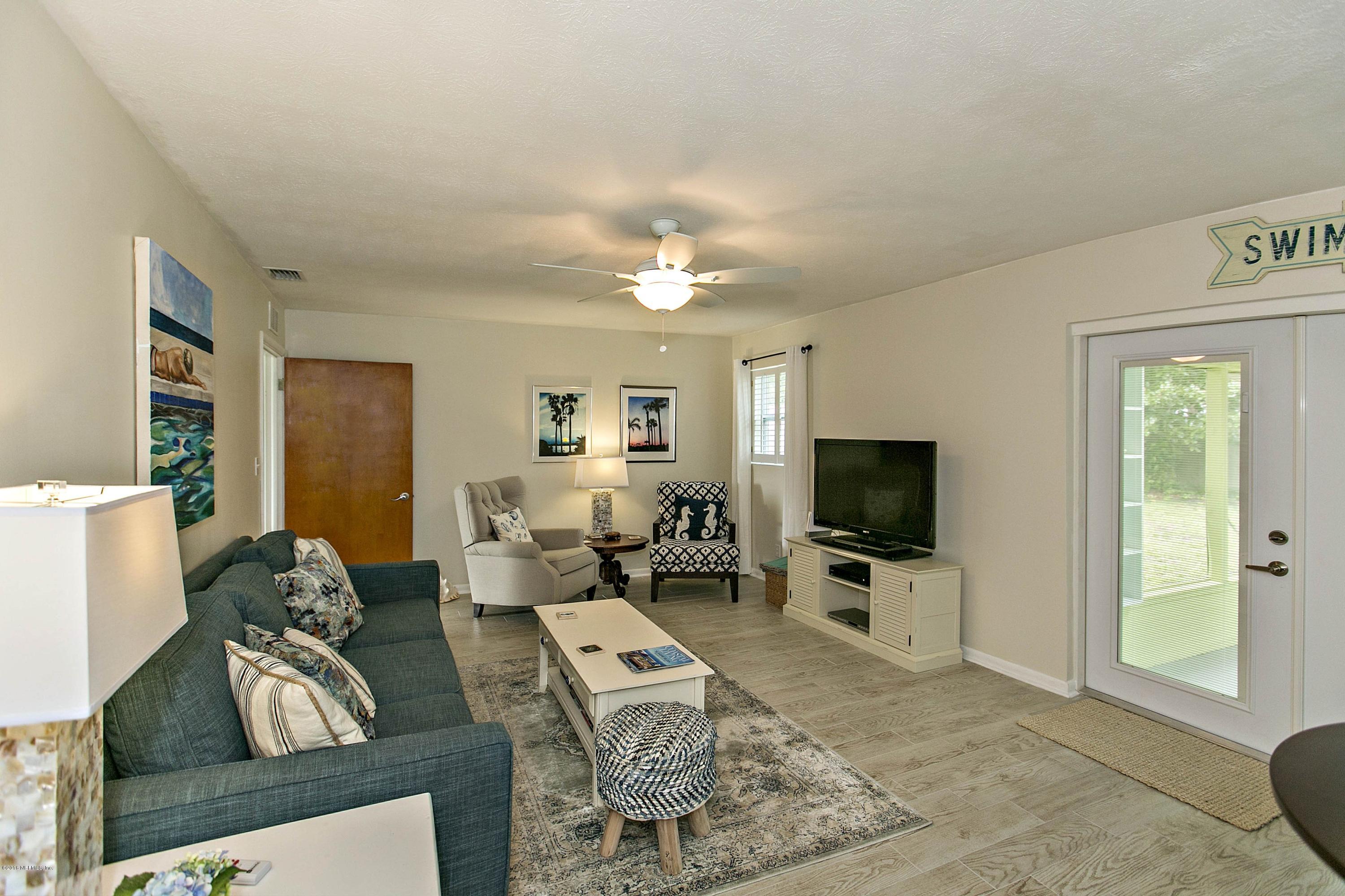 4034 Eunice Road Jacksonville, FL 32250 - Photo 11 of 24 a living room with furniture a flat screen tv and a view of kitchen