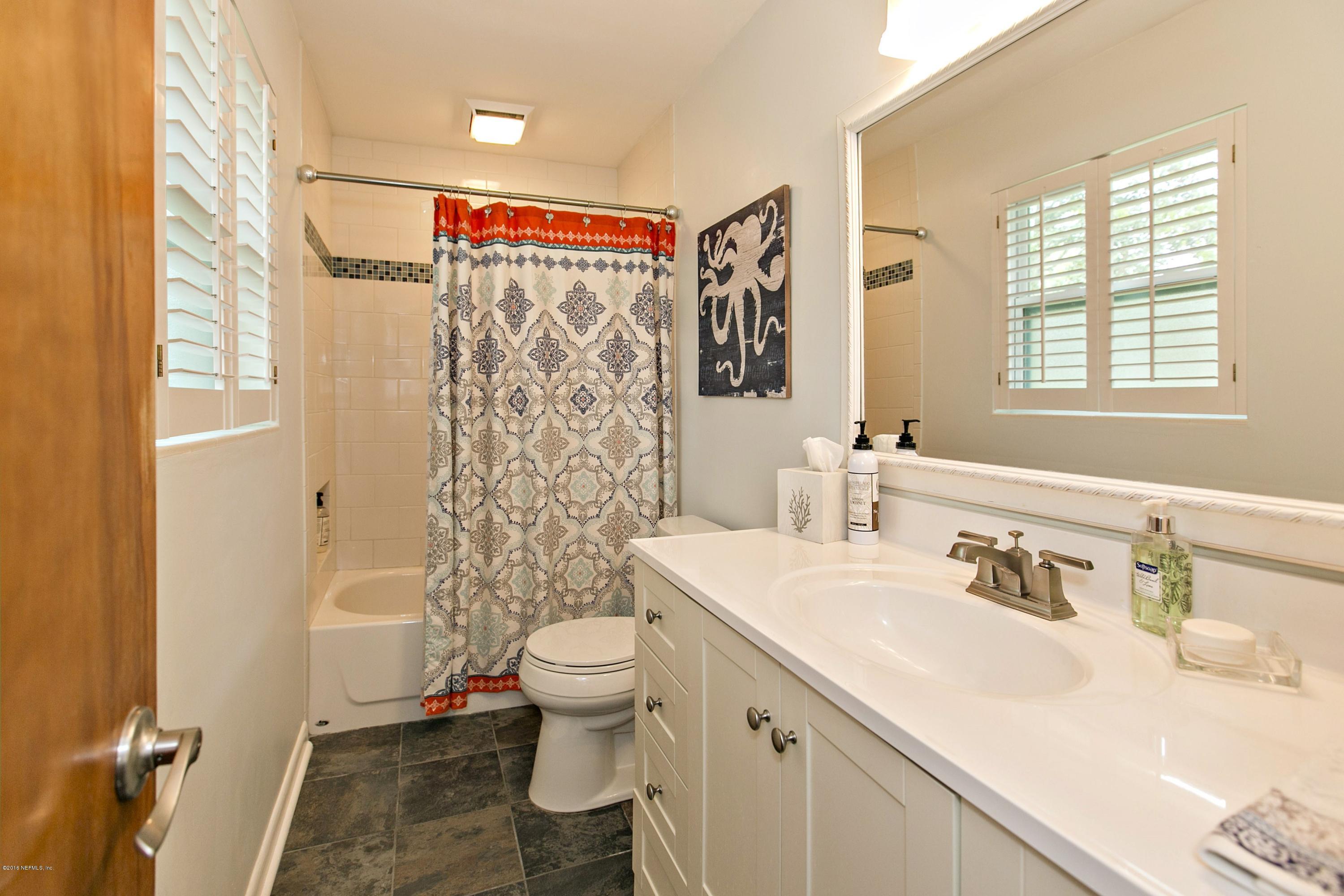 4034 Eunice Road Jacksonville, FL 32250 - Photo 14 of 24 a bathroom with a sink toilet and shower