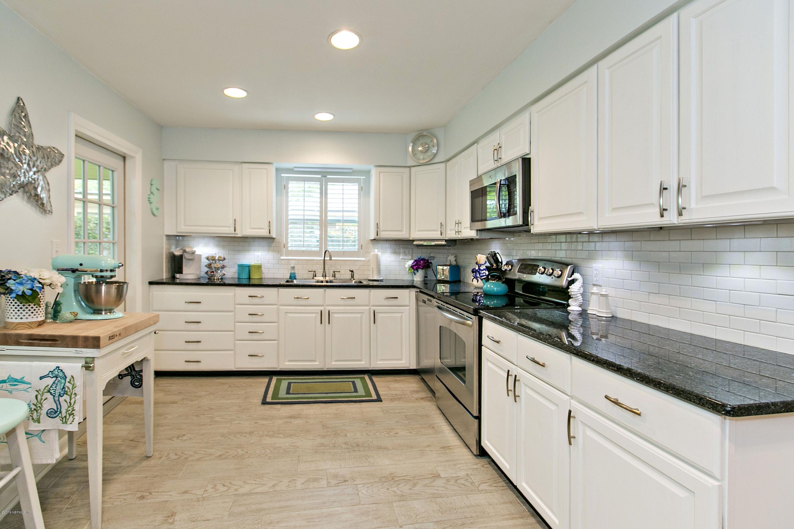 4034 Eunice Road Jacksonville, FL 32250 - Photo 7 of 24 a kitchen with granite countertop white cabinets and white appliances