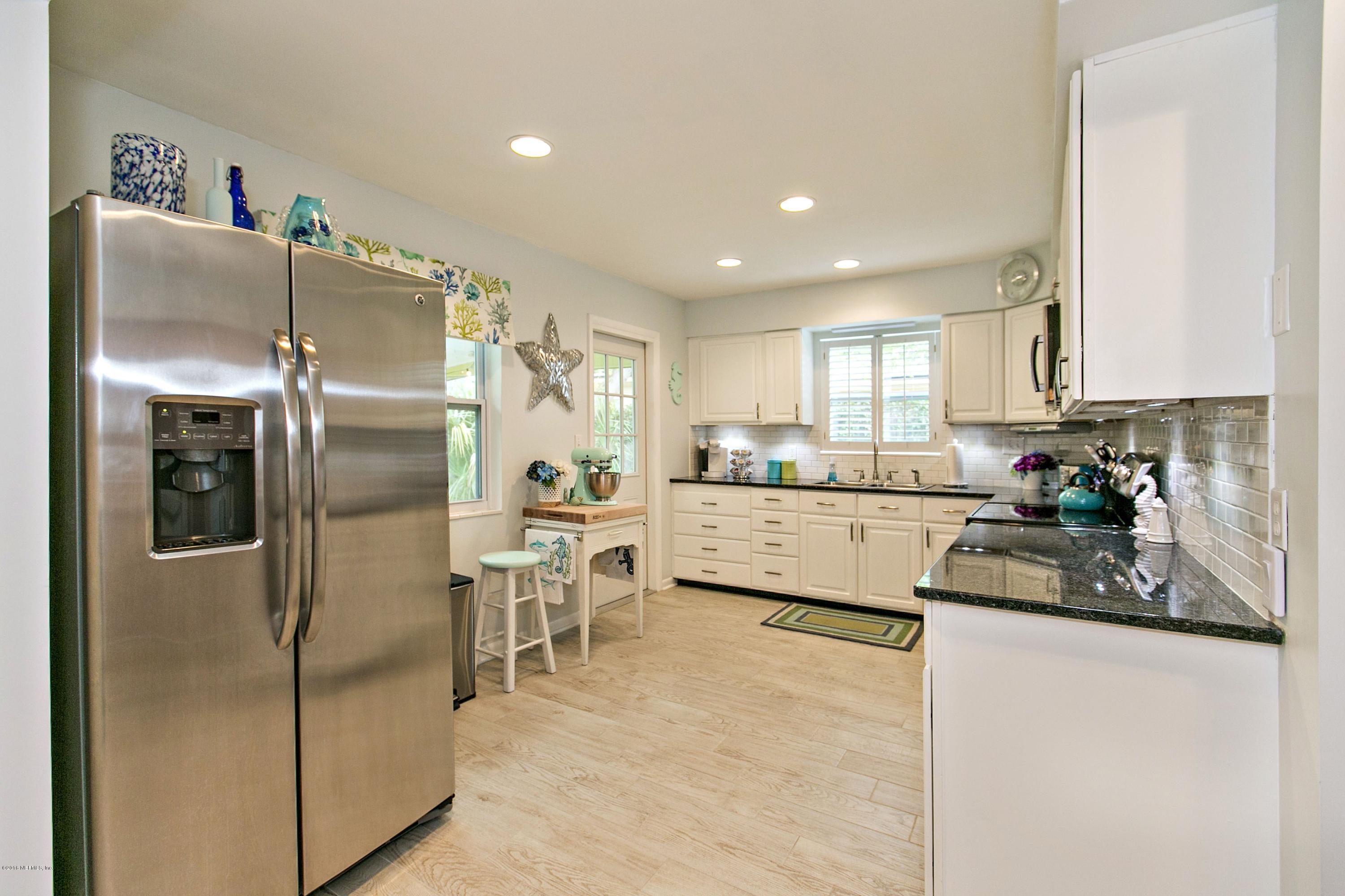 4034 Eunice Road Jacksonville, FL 32250 - Photo 8 of 24 a kitchen with stainless steel appliances granite countertop a refrigerator sink and cabinets