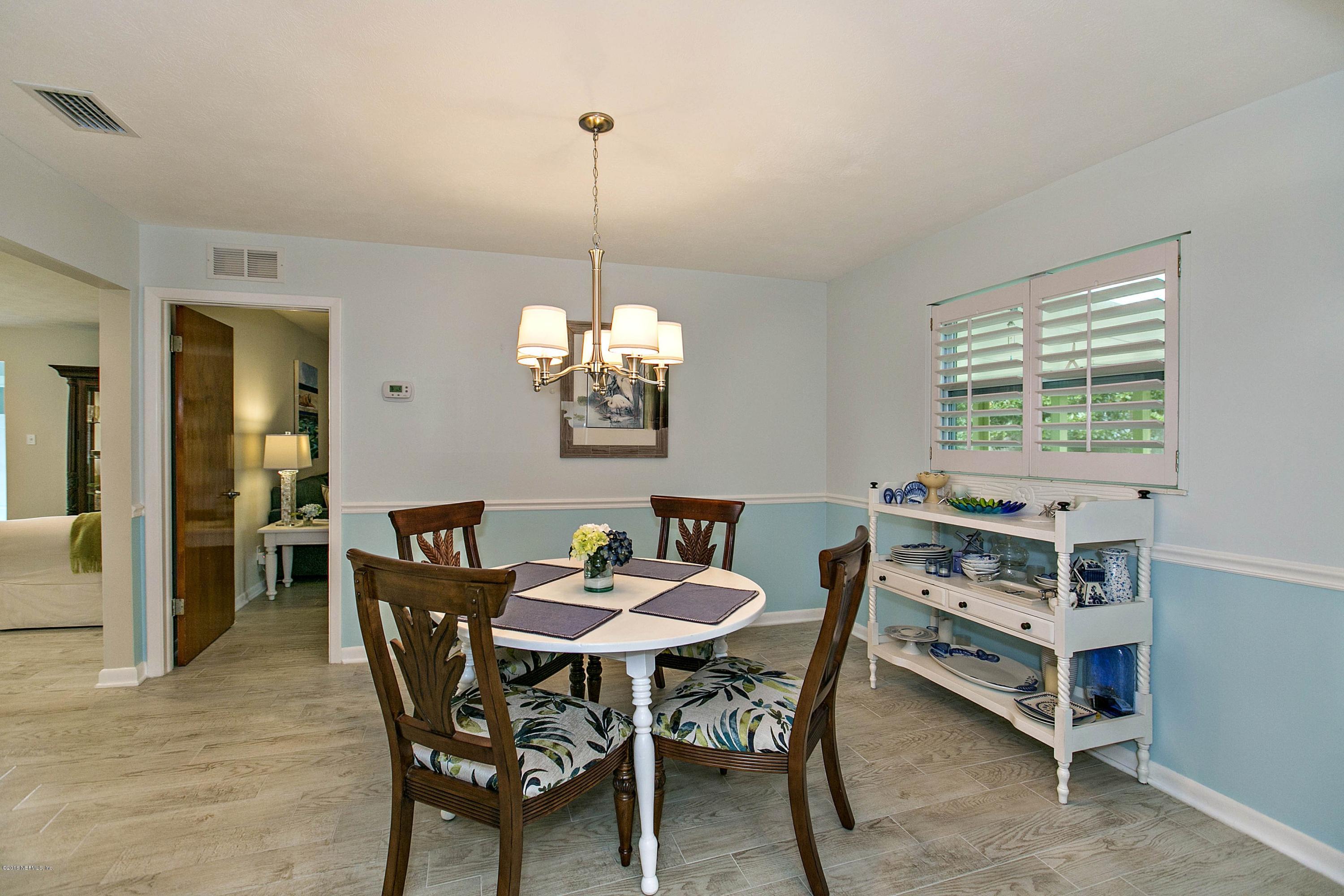 4034 Eunice Road Jacksonville, FL 32250 - Photo 9 of 24 a view of a dining room with furniture window and wooden floor