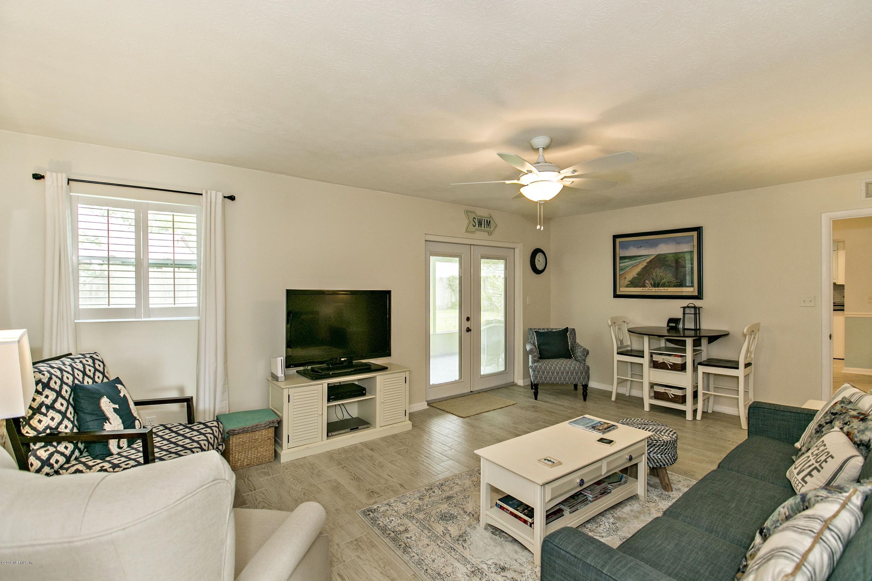 4034 Eunice Road Jacksonville, FL 32250 - Photo 10 of 24 a living room with furniture and a flat screen tv