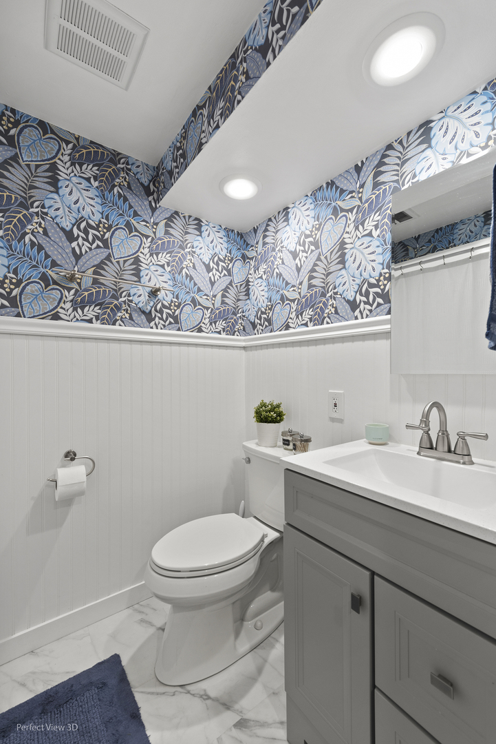 1020 Mitchell Avenue Elmhurst, IL 60126 - Photo 16 of 44 a bathroom with a toilet a sink and mirror