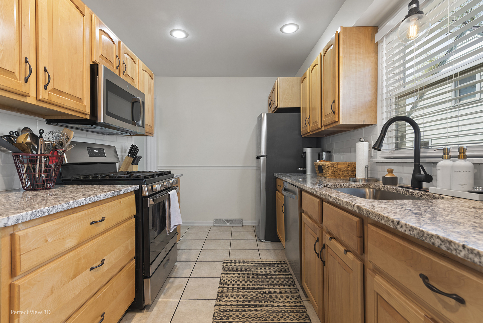 1020 Mitchell Avenue Elmhurst, IL 60126 - Photo 4 of 44 a kitchen with stainless steel appliances granite countertop a stove a sink and a microwave