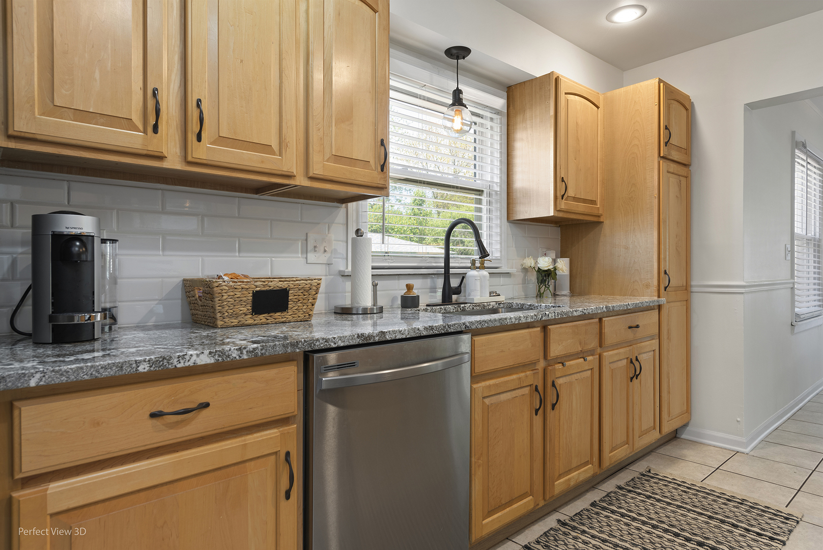 1020 Mitchell Avenue Elmhurst, IL 60126 - Photo 5 of 44 a kitchen with granite countertop a sink stainless steel appliances white cabinets and a window
