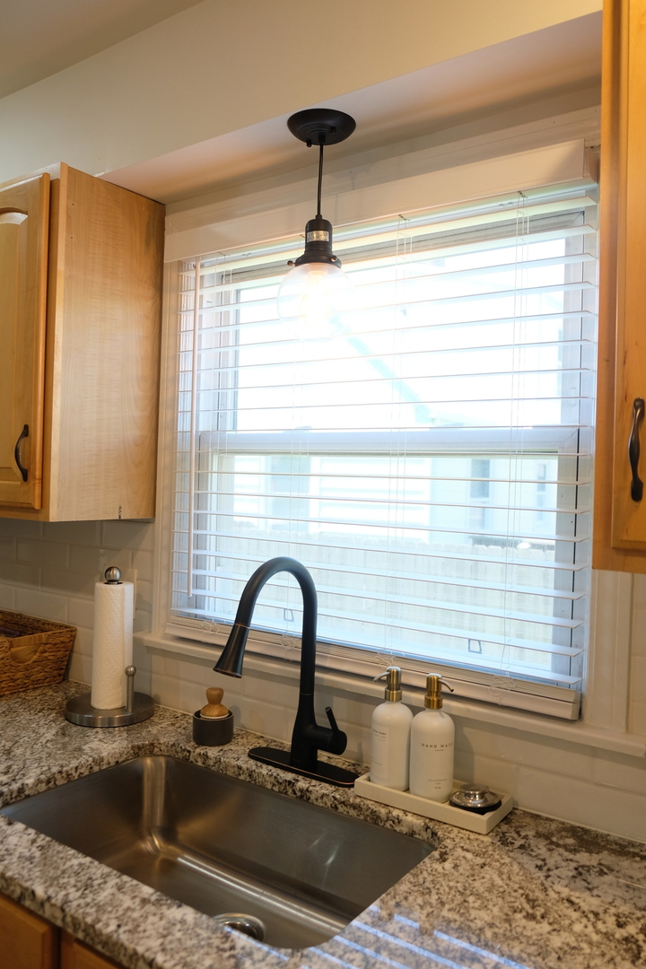 1020 Mitchell Avenue Elmhurst, IL 60126 - Photo 6 of 44 a kitchen with a granite countertop sink and a window