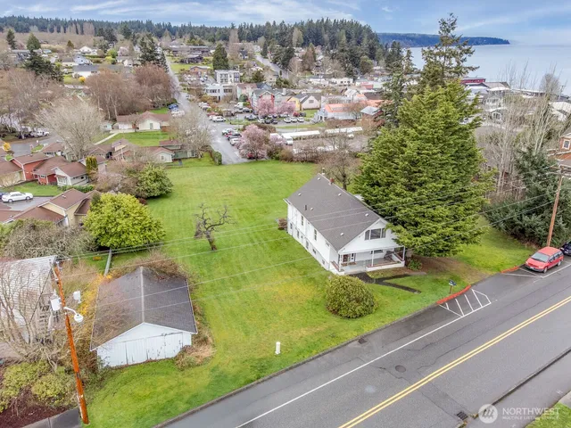 an aerial view of a house with a garden and lake view