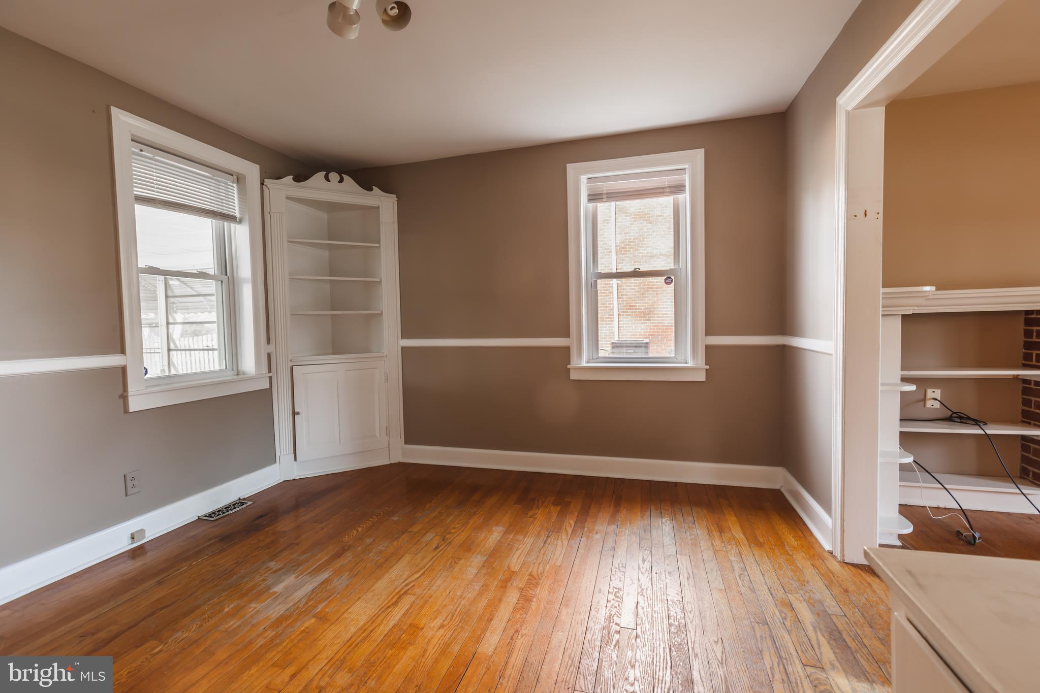 23 Sunset Road Newark, DE 19711 - Photo 19 of 25 an empty room with wooden floor and windows