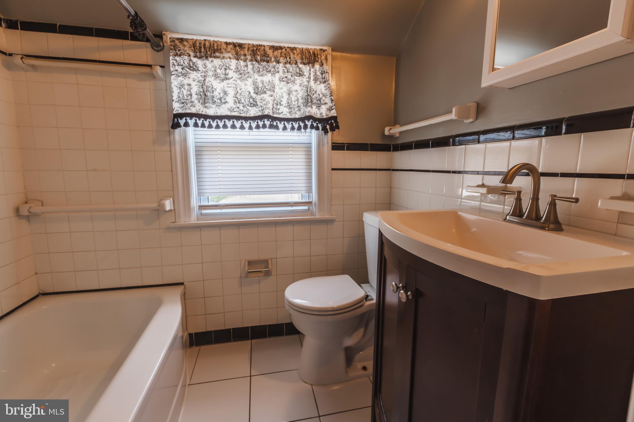 23 Sunset Road Newark, DE 19711 - Photo 20 of 25 a bathroom with a sink a toilet and mirror