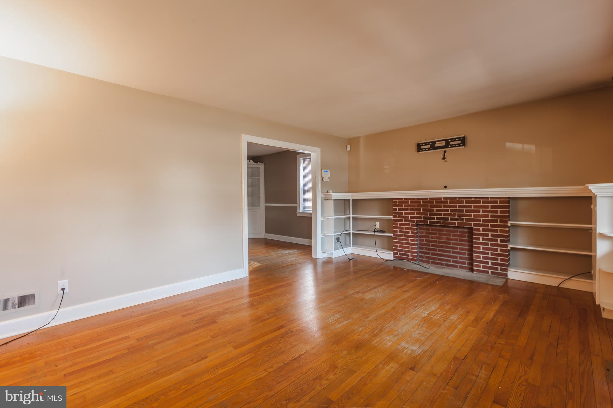 23 Sunset Road Newark, DE 19711 - Photo 3 of 25 a view of an empty room with wooden floor and a window