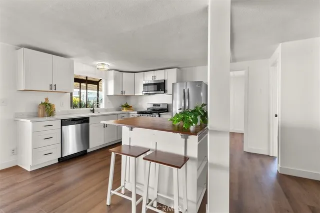 a kitchen with white cabinets and white appliances