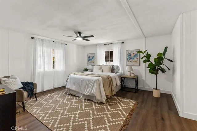 a bedroom with a bed table and a window
