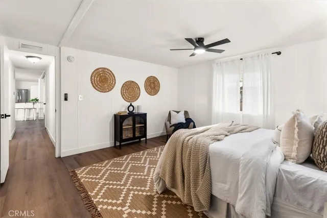 a bedroom with bed and a clock