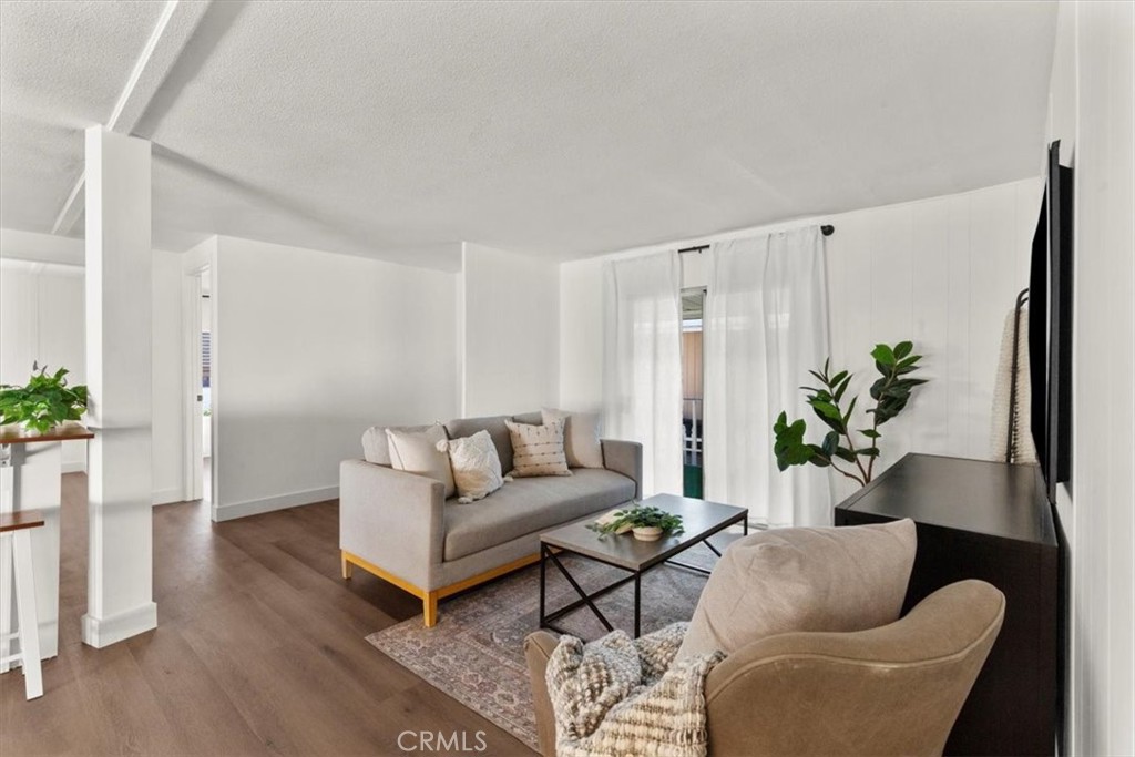 300 North Rampart Street, Unit 127 Orange, CA 92868 - Photo 19 of 28 Living Room area of the home at 300 N Rampart St TRAILER 127, Orange, CA. Features ample natural light and open-concept design