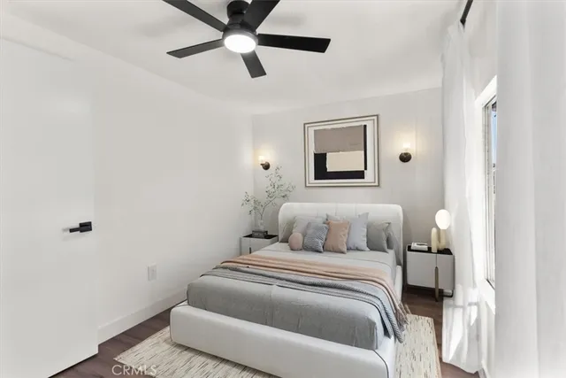 a bedroom with a bed and a painting on the wall