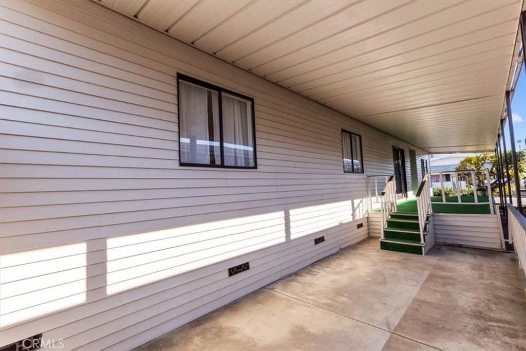 300 North Rampart Street, Unit 127 Orange, CA 92868 - Photo 26 of 37 Right Side Exterior view of the home at 300 N Rampart St TRAILER 127, Orange, CA. Shows the entrance side, adjacent carport, or proximity to neighbors