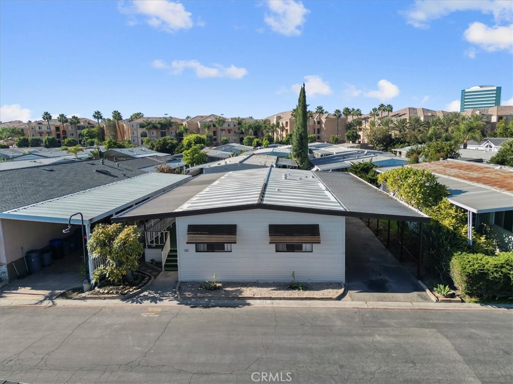 300 North Rampart Street, Unit 127 Orange, CA 92868 - Photo 5 of 37 Exterior view of the home at 300 N Rampart St TRAILER 127, Orange, CA. Features a covered porch/carport area and well-maintained landscaping