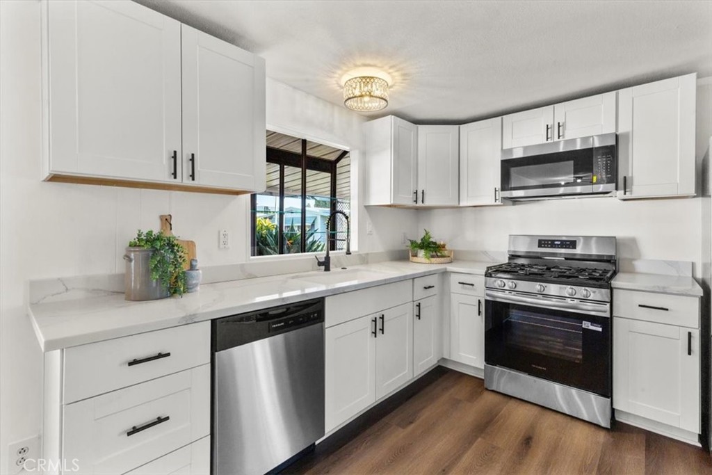 300 North Rampart Street, Unit 127 Orange, CA 92868 - Photo 7 of 37 Kitchen of the home at 300 N Rampart St TRAILER 127, Orange, CA. Showcases updated appliances and generous cabinet space