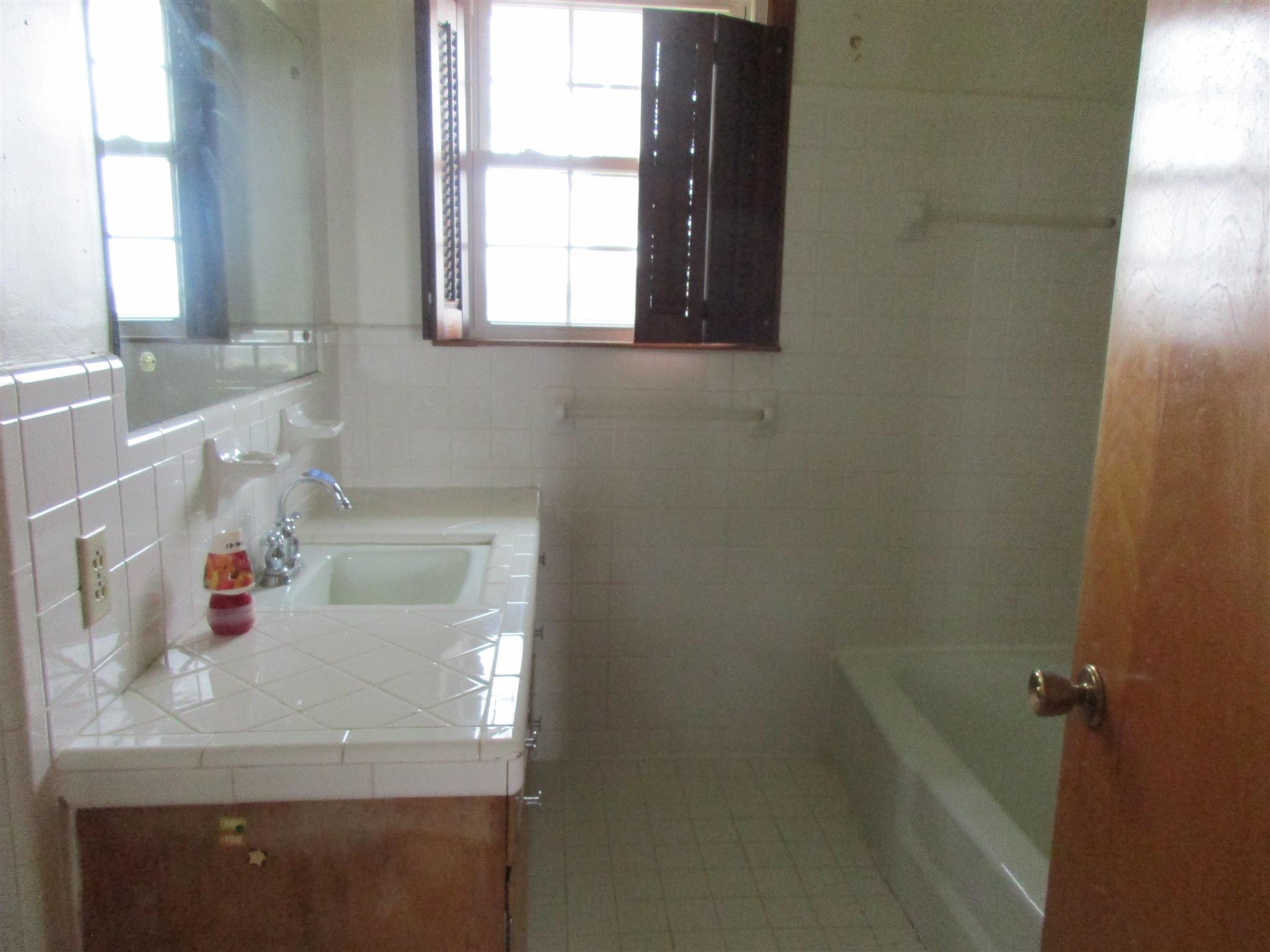 3779 Buck Road Clarksville, TN 37043 - Photo 11 of 12 a bathroom with a tub sink and window