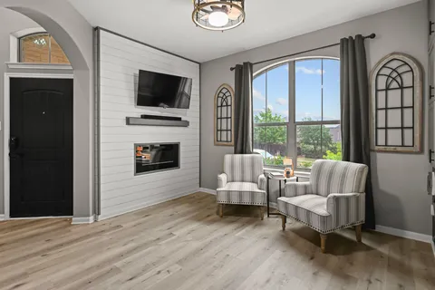 a living room with furniture fireplace and flat screen tv