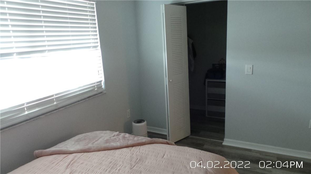 5001 Wiles Road, Unit 106 Pompano Beach, FL 33073 - Photo 11 of 31 a bedroom with a bed and a window