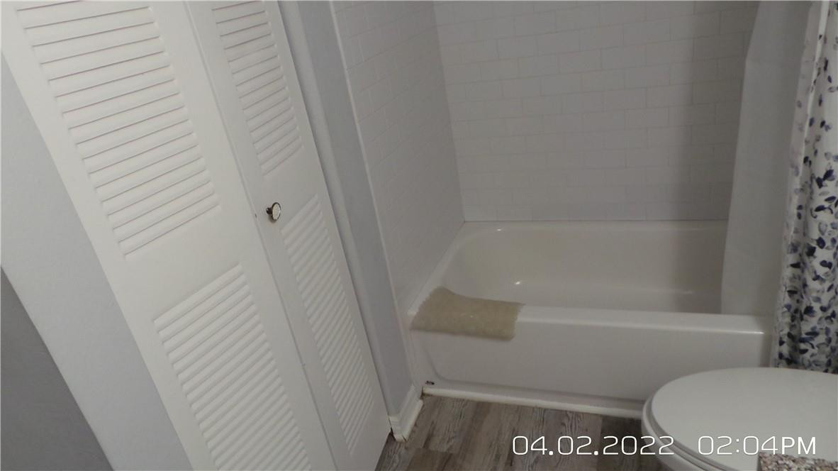 5001 Wiles Road, Unit 106 Pompano Beach, FL 33073 - Photo 14 of 31 a bathroom with a toilet and a shower