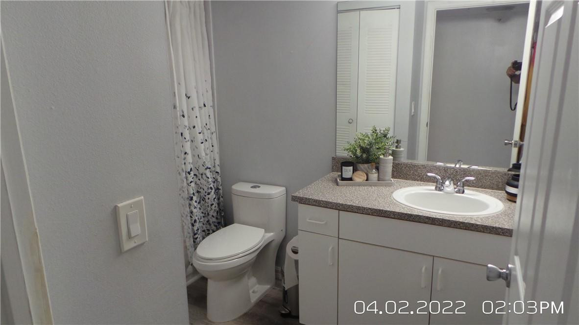 5001 Wiles Road, Unit 106 Pompano Beach, FL 33073 - Photo 16 of 31 a bathroom with a toilet sink and mirror