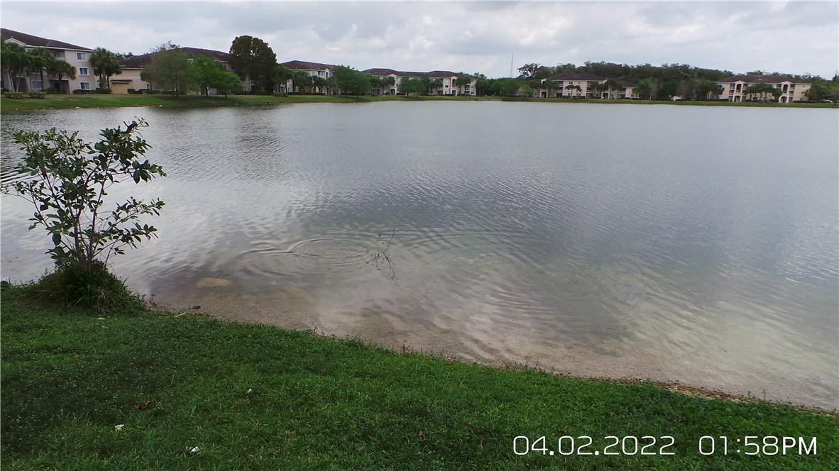 5001 Wiles Road, Unit 106 Pompano Beach, FL 33073 - Photo 25 of 31 a view of lake with mountain in the background