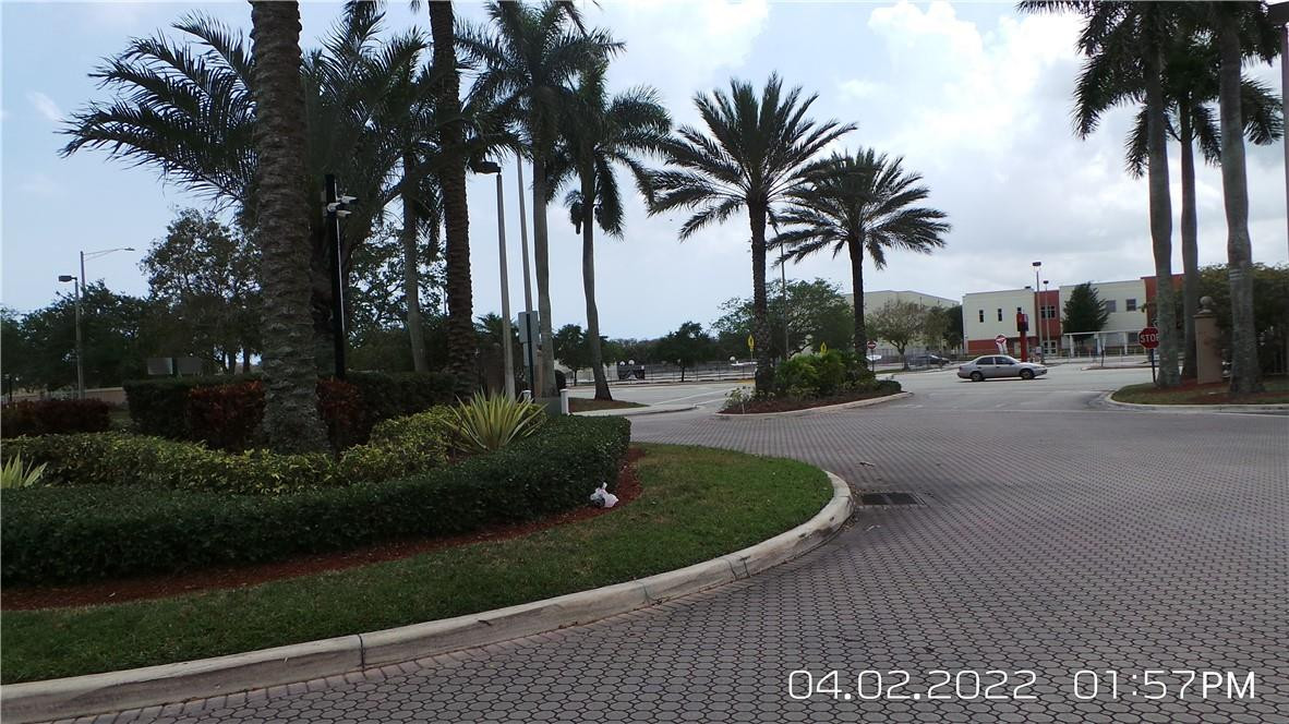 5001 Wiles Road, Unit 106 Pompano Beach, FL 33073 - Photo 26 of 31 a view of a swimming pool with a table and chairs