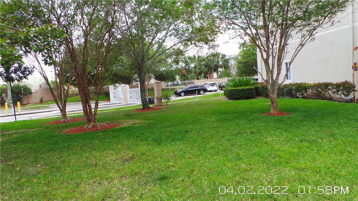5001 Wiles Road, Unit 106 Pompano Beach, FL 33073 - Photo 27 of 31 a garden with trees