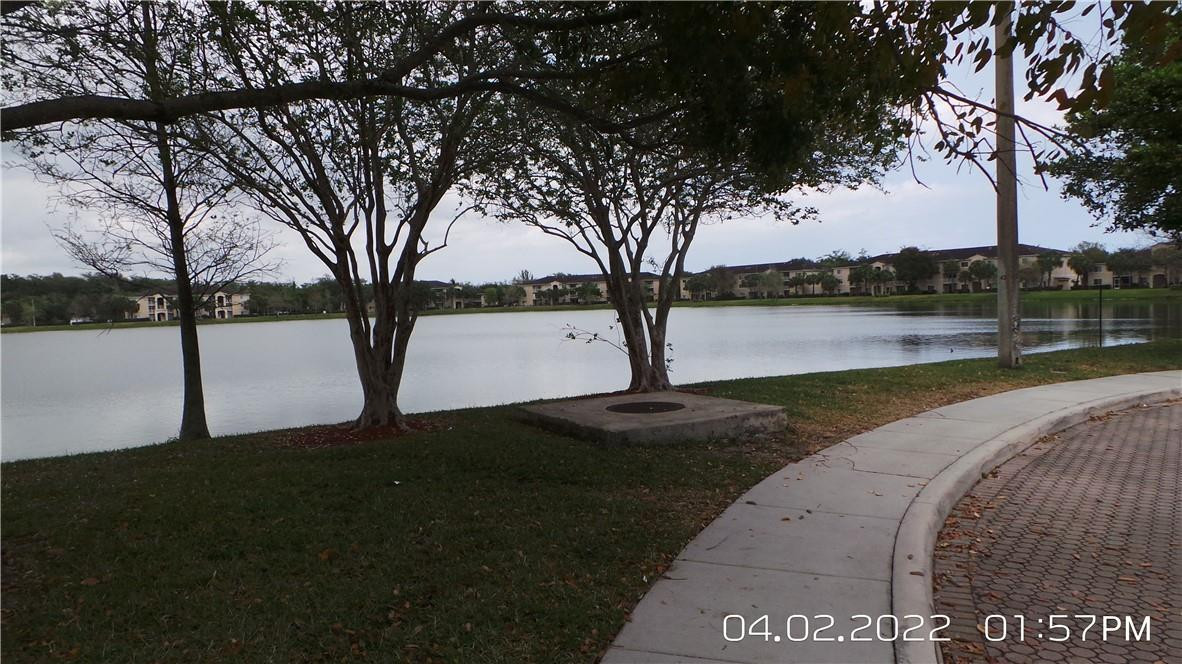 5001 Wiles Road, Unit 106 Pompano Beach, FL 33073 - Photo 29 of 31 a view of a street with a yard