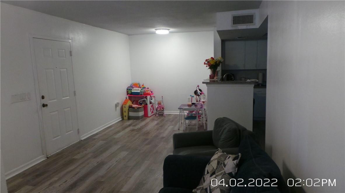 5001 Wiles Road, Unit 106 Pompano Beach, FL 33073 - Photo 7 of 31 a room with furniture and wooden floor
