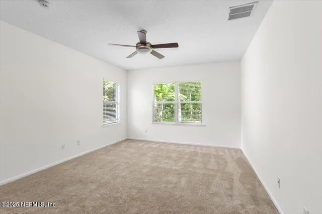 an empty room with windows and closet