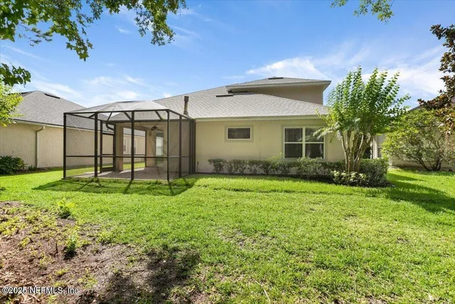 a view of a backyard with large trees