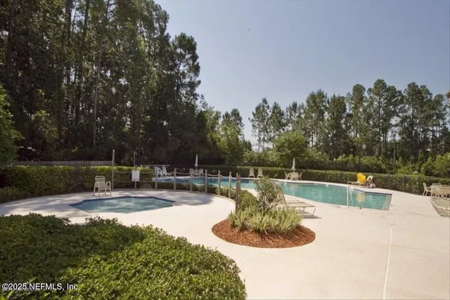a view of a swimming pool with chairs