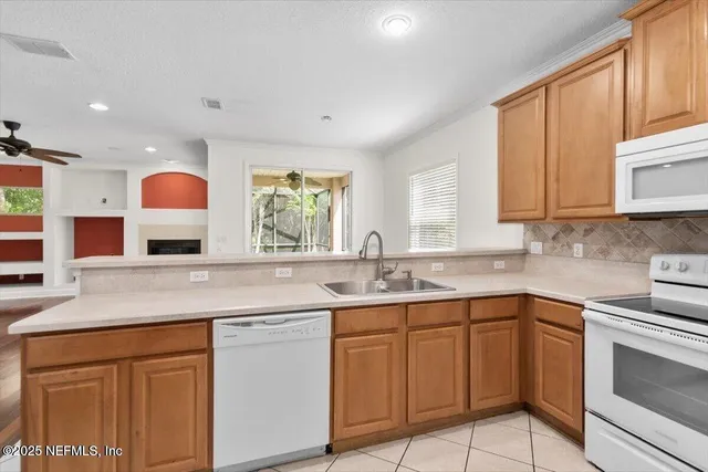 a kitchen with cabinets appliances and a sink