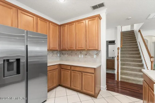 a kitchen with stainless steel appliances granite countertop a refrigerator and cabinets