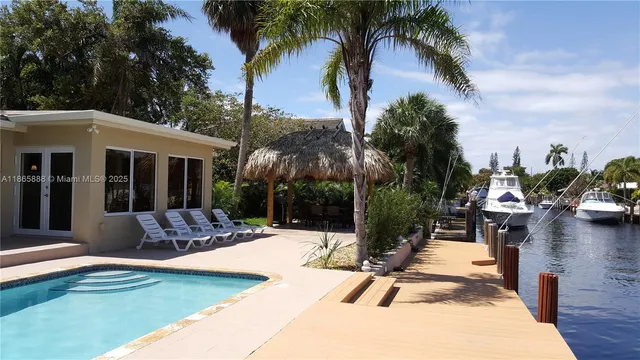 a view of a house with backyard patio and swimming pool