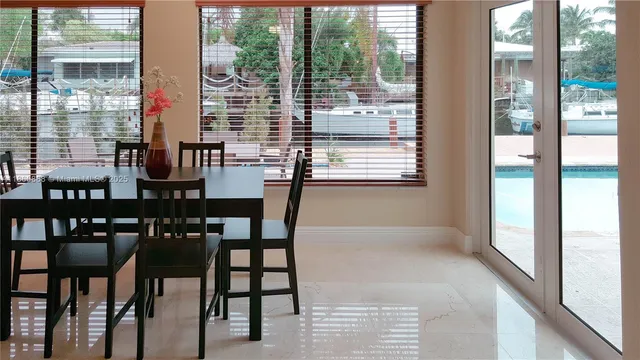 a view of a dining room with furniture and a window