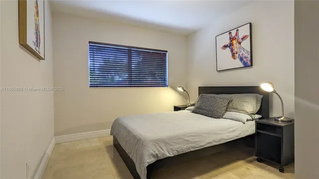 a bedroom with a bed and a night stand