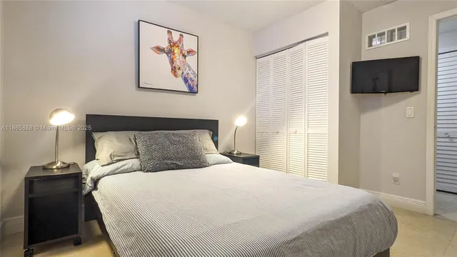 a bedroom with a bed and a tv