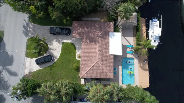 an aerial view of a house with yard and outdoor seating