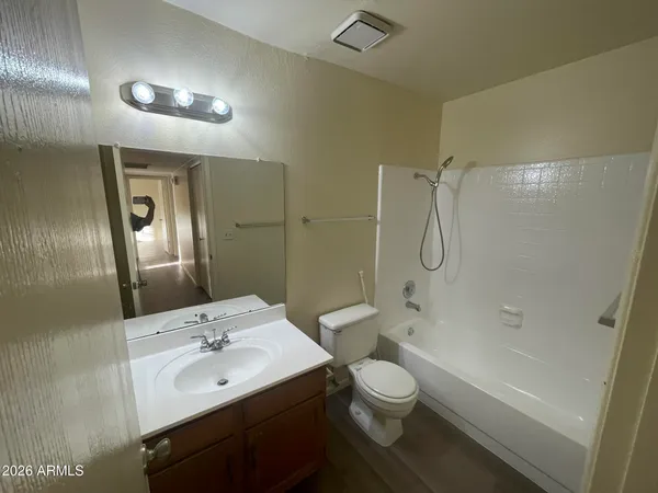 a bathroom with a double vanity sink toilet mirror and shower